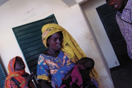 A woman holding a sick child